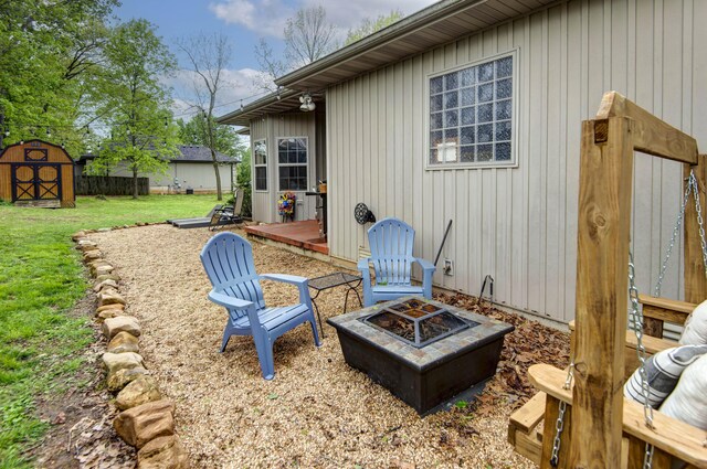 1376 N 14th St, Ozark, MO 65721 - exterior space with a fire pit, a shed, and an outbuilding