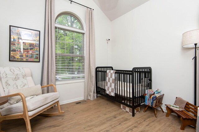 1376 N 14th St, Ozark, MO 65721 - bedroom with light wood-style floors, a crib, vaulted ceiling, and multiple windows