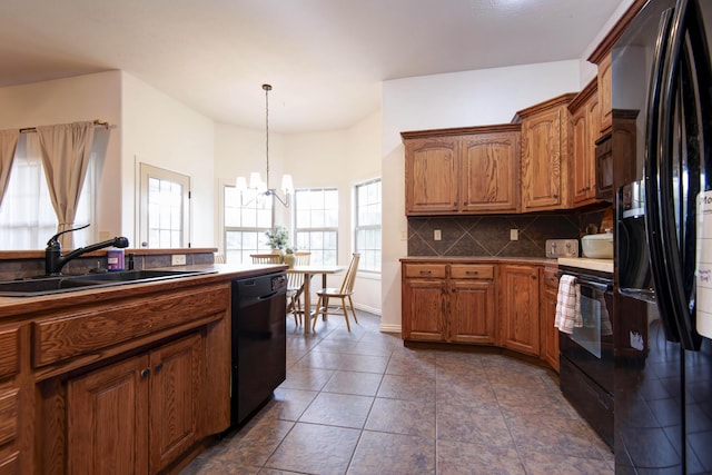 1376 N 14th St, Ozark, MO 65721 - kitchen featuring an inviting chandelier, brown cabinets, tasteful backsplash, a sink, and black appliances