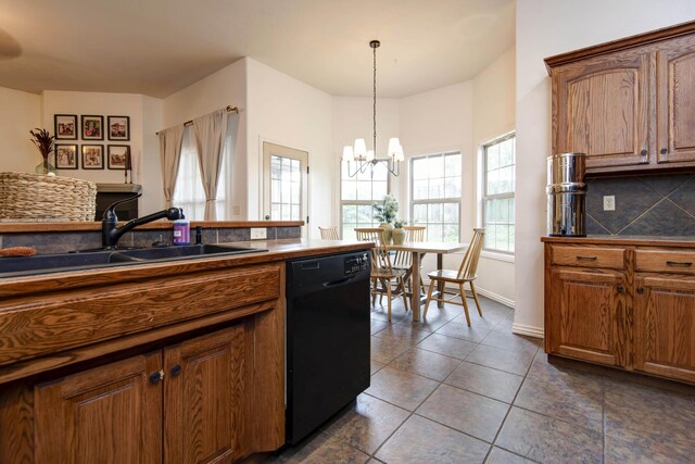 1376 N 14th St, Ozark, MO 65721 - kitchen featuring dark countertops, a notable chandelier, a sink, dishwasher, and tasteful backsplash