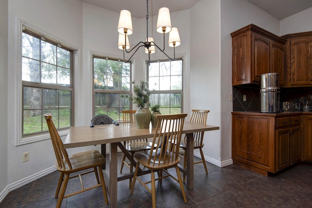 1376 N 14th St, Ozark, MO 65721 - dining space with dark tile patterned floors, baseboards, an inviting chandelier, and a high ceiling