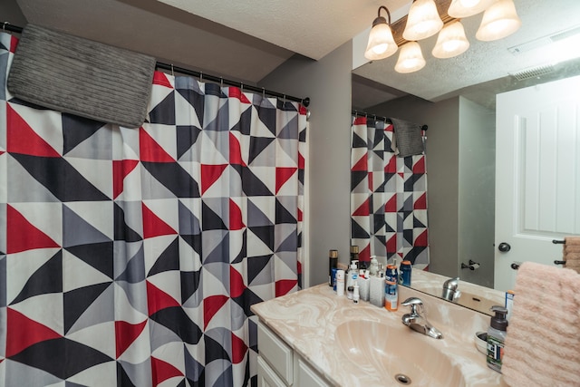 bathroom featuring visible vents, curtained shower, and vanity