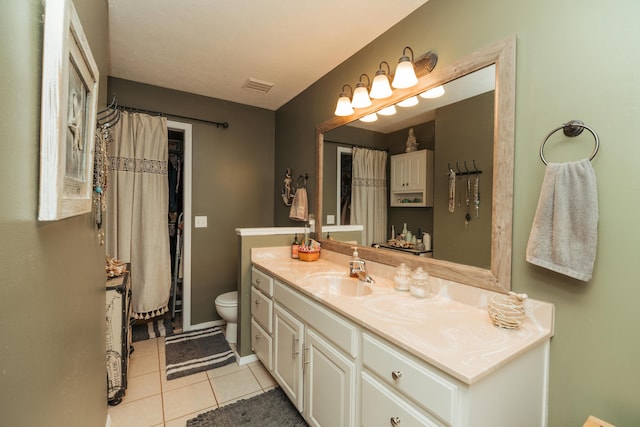 full bathroom featuring tile patterned flooring, vanity, toilet, baseboards, and visible vents