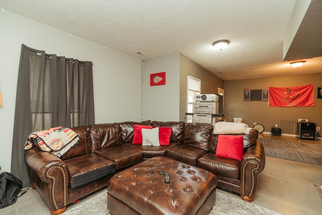 living room with carpet and a textured ceiling