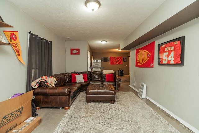 carpeted living area with a textured ceiling