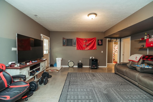 living area with baseboards and concrete floors