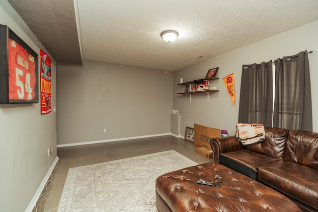 living room with baseboards and a textured ceiling