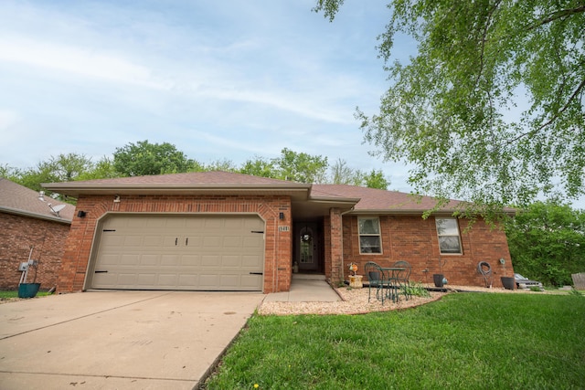 ranch-style home featuring concrete driveway, brick siding, an attached garage, and a front yard