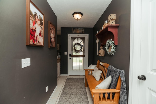 doorway to outside with light tile patterned floors
