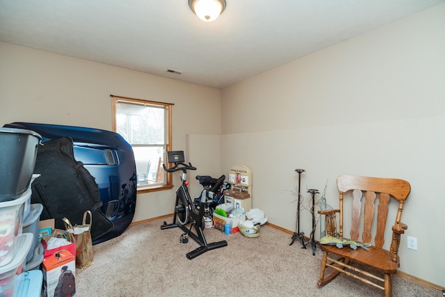 workout room featuring baseboards, carpet, and visible vents
