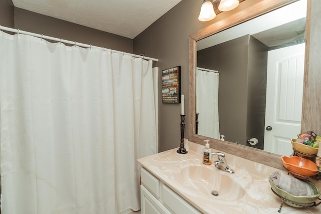 bathroom with a textured ceiling and vanity