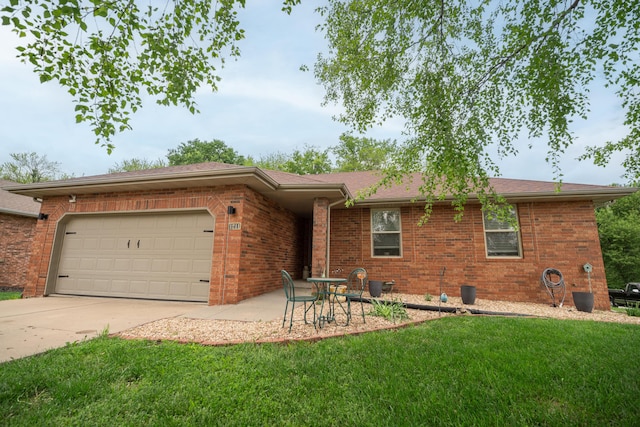 ranch-style house featuring concrete driveway, brick siding, a front lawn, and a garage