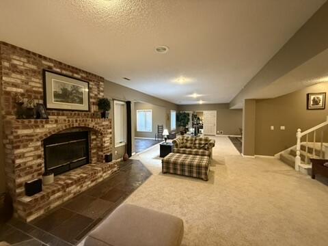 living room featuring stairway and a fireplace