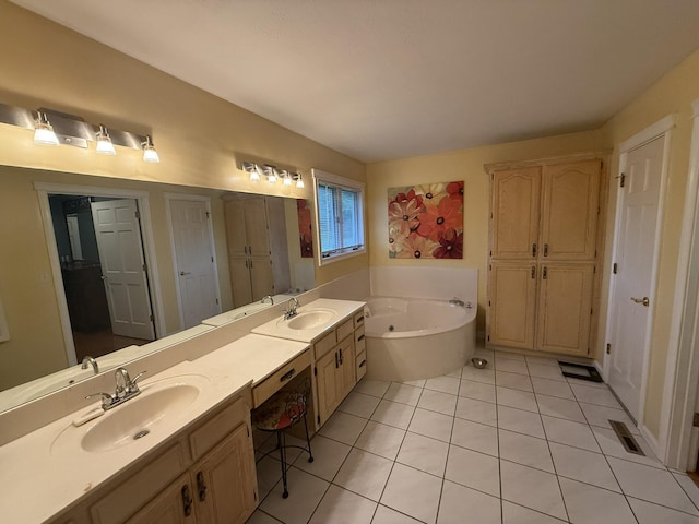 full bathroom featuring a sink, tile patterned flooring, a tub with jets, and double vanity