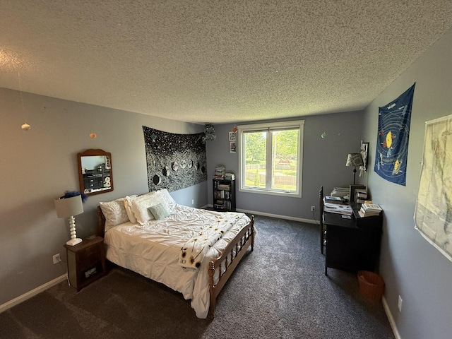 bedroom featuring carpet, baseboards, and a textured ceiling