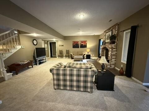 carpeted living area featuring a textured ceiling, stairway, a fireplace, and baseboards