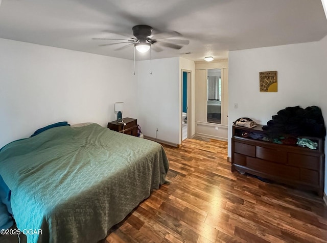 bedroom featuring baseboards, ceiling fan, and wood finished floors