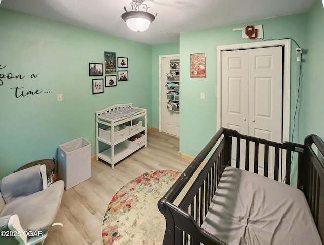 bedroom featuring a closet, baseboards, and light wood-type flooring