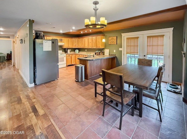dining area with french doors, recessed lighting, and a chandelier