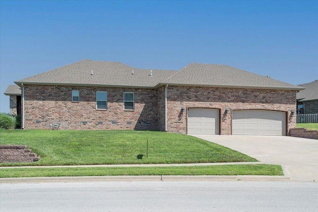 view of front of property with a garage, concrete driveway, a front lawn, and brick siding