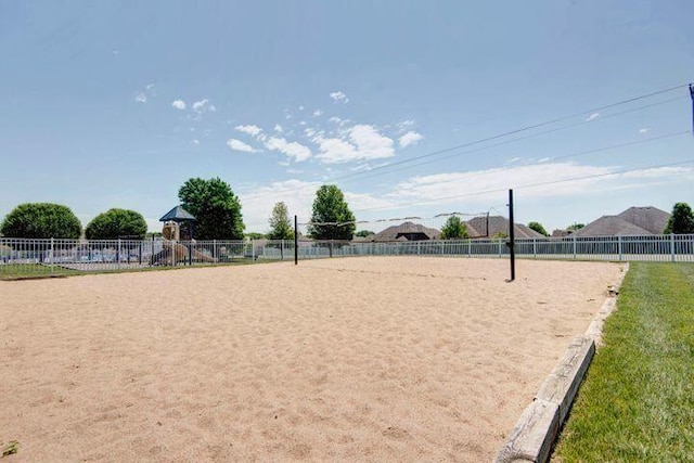 view of home's community featuring fence, playground community, and volleyball court