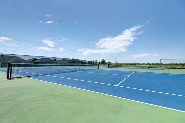 view of sport court featuring fence