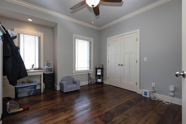 interior space with wood-type flooring, crown molding, baseboards, and ceiling fan