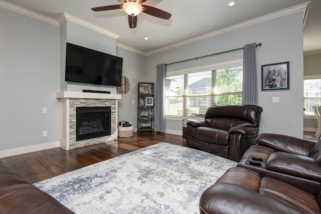 living area featuring crown molding, baseboards, ceiling fan, and wood finished floors
