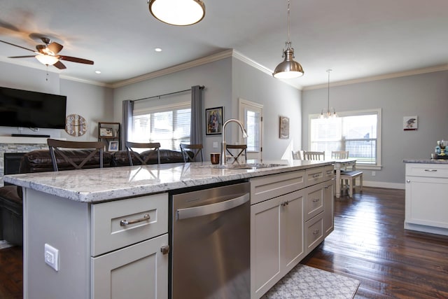 kitchen with light stone countertops, dark wood-type flooring, a sink, ceiling fan with notable chandelier, and dishwasher