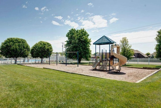community jungle gym with a lawn and fence