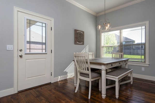 dining room featuring wood-type flooring, ornamental molding, baseboards, and a notable chandelier