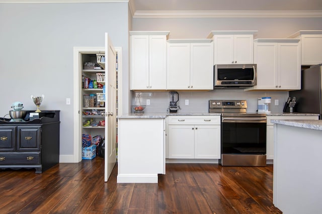 kitchen featuring crown molding, stainless steel appliances, white cabinetry, and dark wood-type flooring