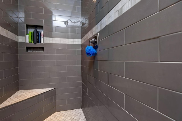 full bath with a tile shower