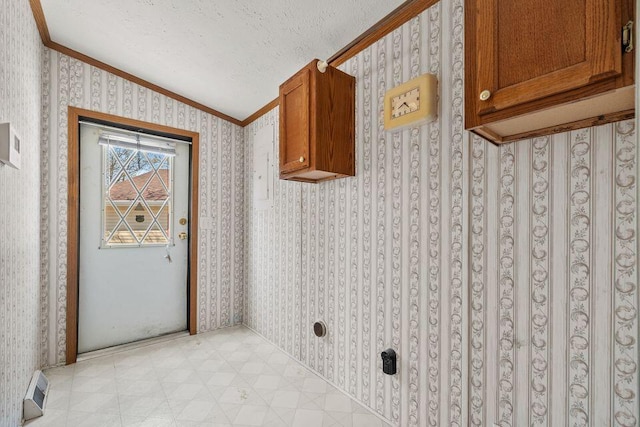 26929 Cordwood Ridge Dr, Shell Knob, MO 65747 - laundry room featuring light floors, ornamental molding, wallpapered walls, and a textured ceiling