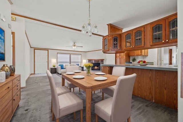 26929 Cordwood Ridge Dr, Shell Knob, MO 65747 - dining space with ceiling fan with notable chandelier, carpet flooring, and a warm lit fireplace