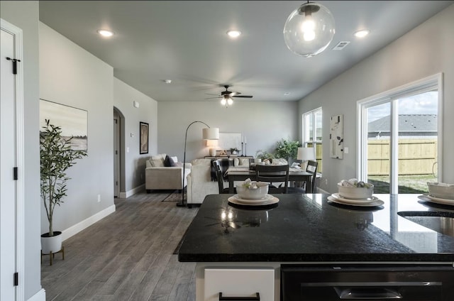 kitchen with ceiling fan, dark wood-style flooring, visible vents, baseboards, and wine cooler