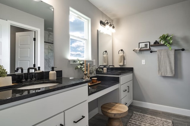 bathroom featuring baseboards, wood finished floors, and vanity
