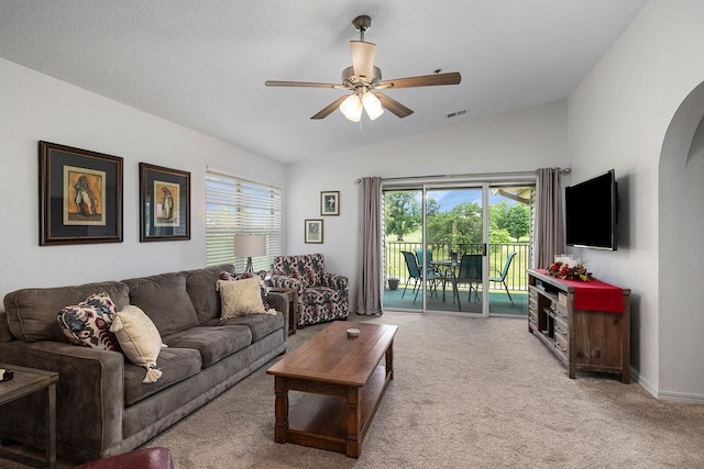 carpeted living area with a ceiling fan, baseboards, vaulted ceiling, and visible vents