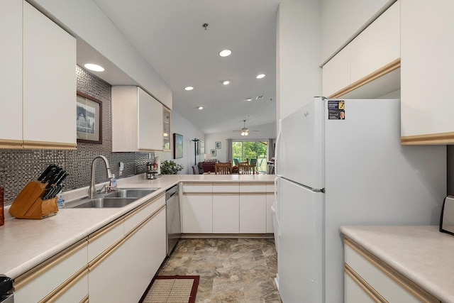 kitchen featuring stainless steel dishwasher, decorative backsplash, recessed lighting, light countertops, and a sink