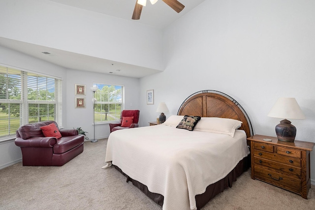 bedroom with carpet floors, ceiling fan, baseboards, and lofted ceiling