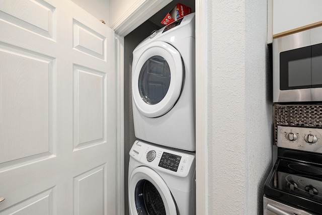 laundry area featuring laundry area and stacked washer / dryer
