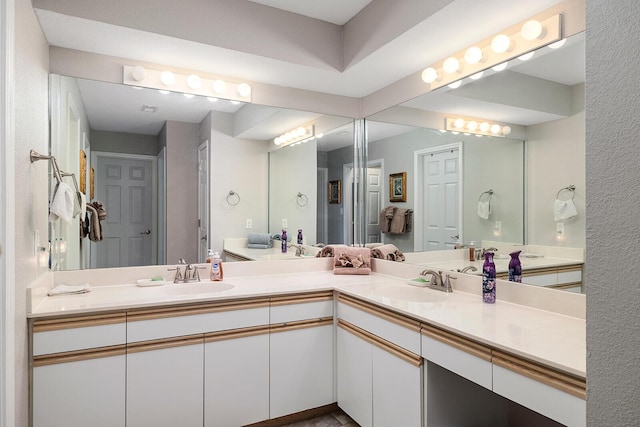 full bath featuring double vanity and a sink