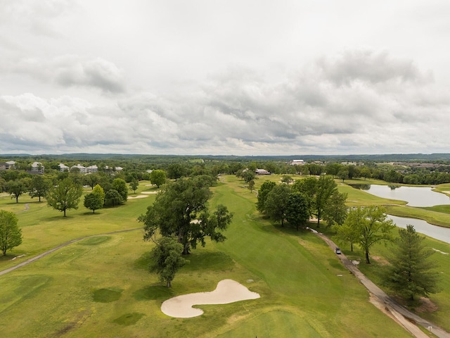 birds eye view of property with a water view and view of golf course