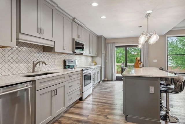 kitchen featuring plenty of natural light, a sink, gray cabinets, and appliances with stainless steel finishes
