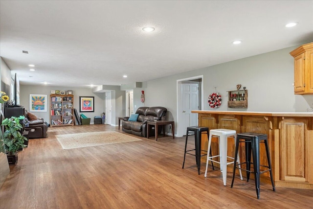 living area with recessed lighting and light wood finished floors