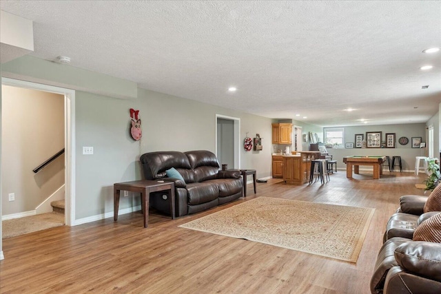 living area featuring billiards, a textured ceiling, light wood-type flooring, stairway, and recessed lighting