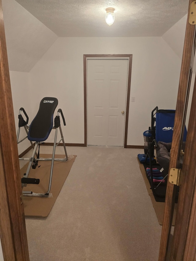 3725 E Shelby Rd, Springfield, MO 65803 - exercise area with vaulted ceiling, light carpet, a textured ceiling, and baseboards