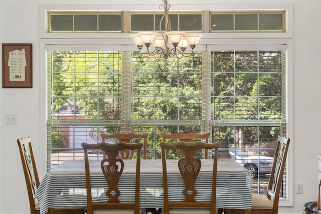 unfurnished dining area with an inviting chandelier
