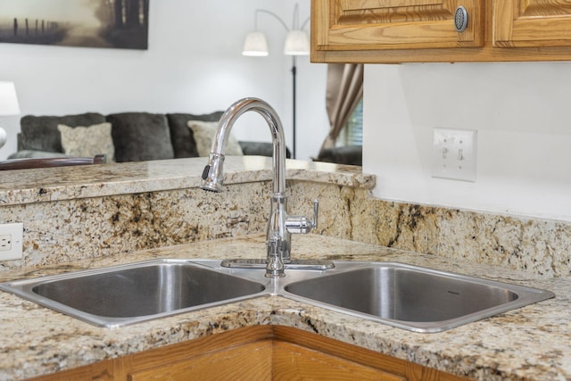 interior details featuring light countertops, brown cabinetry, and a sink