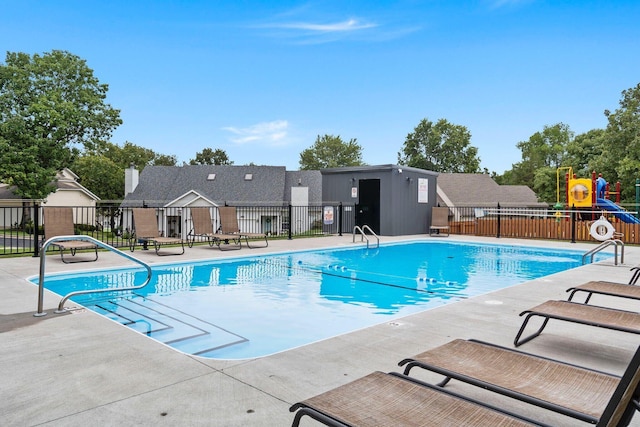 pool with fence and a patio